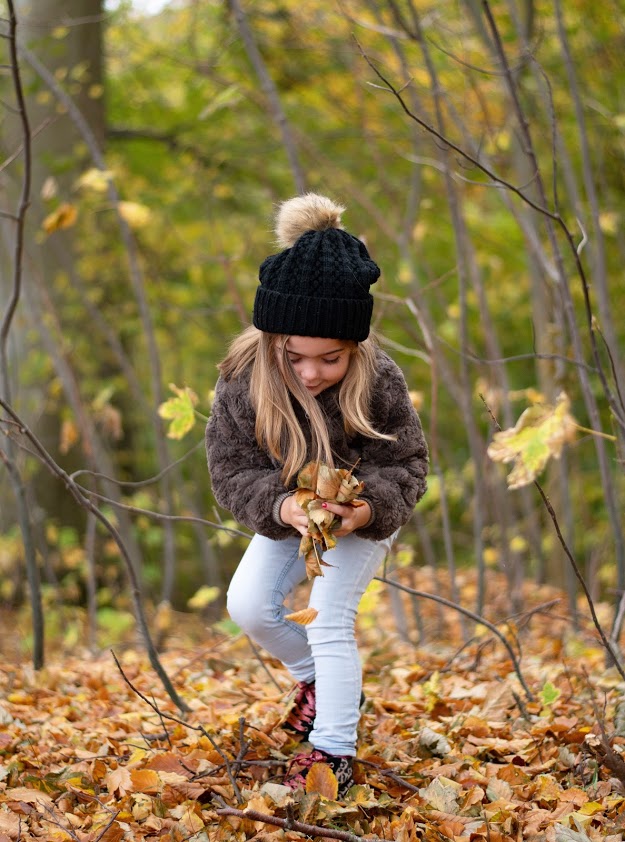 Pige leger i den smukke efterårs skov