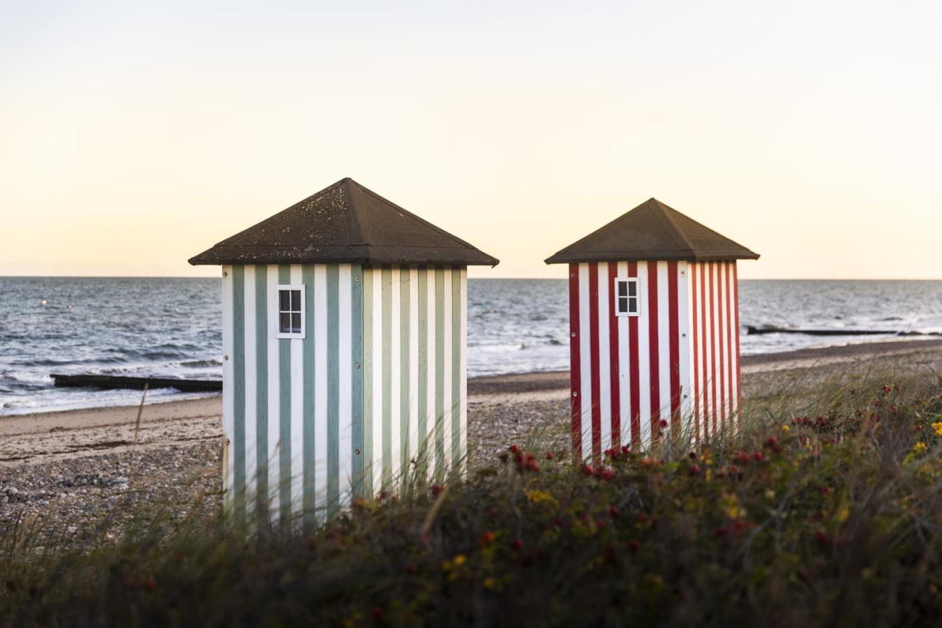 Iconic striped bathing houses on the beach in Rågeleje