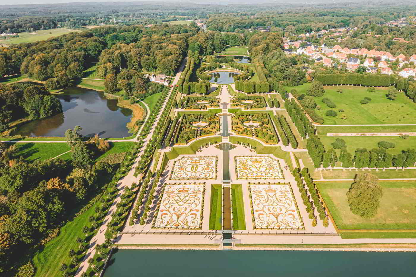 The Baroque Garden at Frederiksborg Castle seen from the air with symmetric paths and the opal lake.