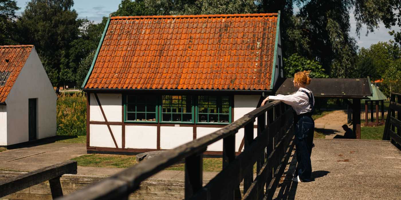 En kvinde står på broen over kanalerne i Frederiksværk