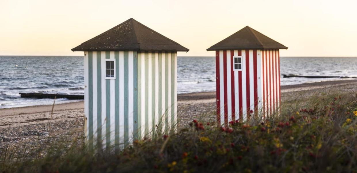 Iconic striped bathing houses on the beach in Rågeleje