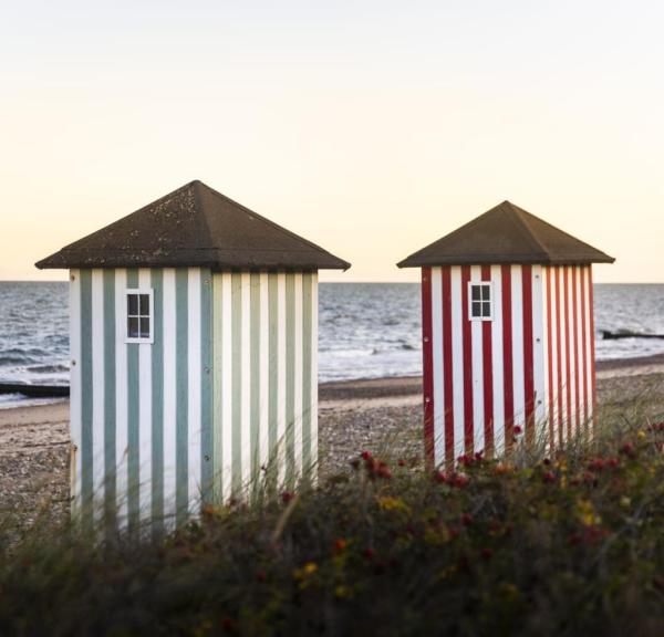 Iconic striped bathing houses on the beach in Rågeleje