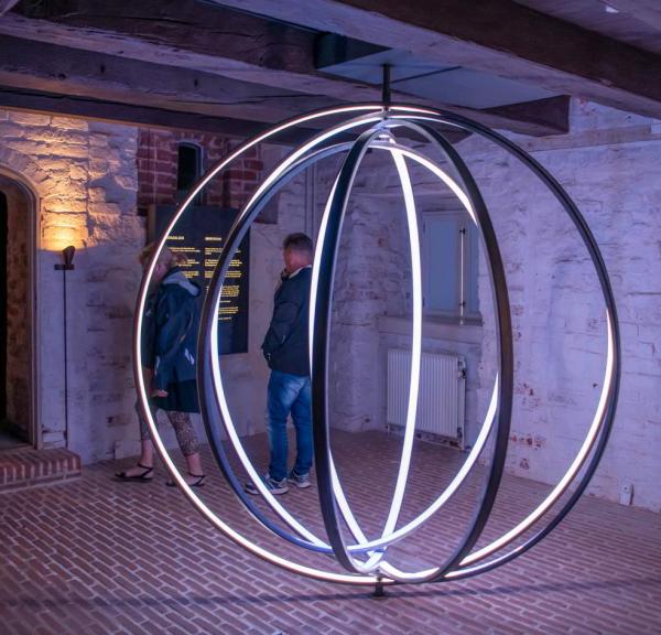 A large circle of light evocatively illustrates the monks' daily life at Esrum Abbey